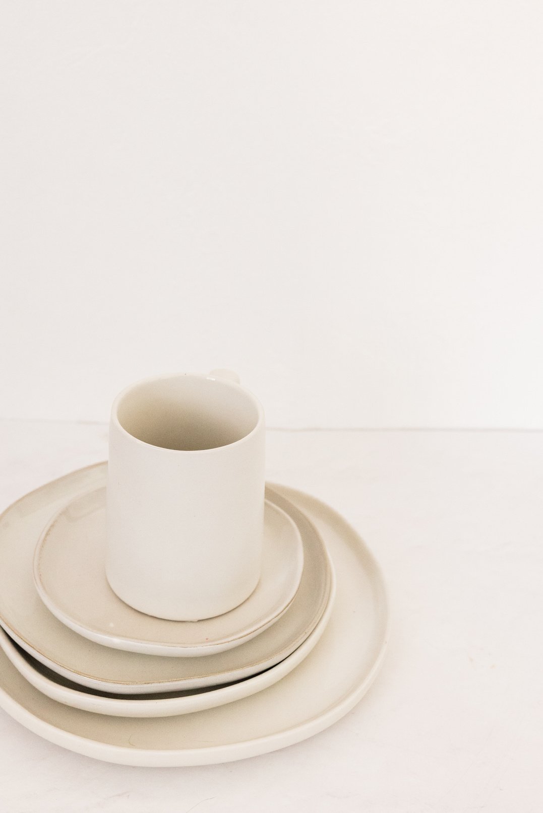 Ceramic Cup on Top of Plates on White Background